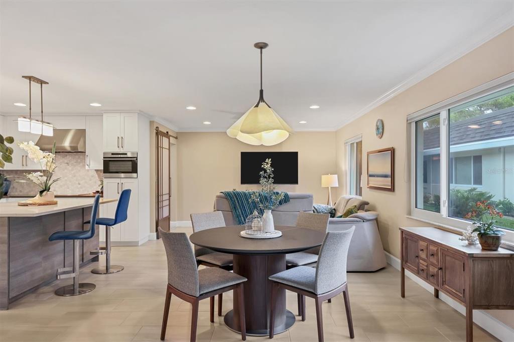 1900 Benjamin Franklin Drive, Unit V15 Sarasota, FL 34236 - Photo 12 of 39 a dining room with furniture window and wooden floor