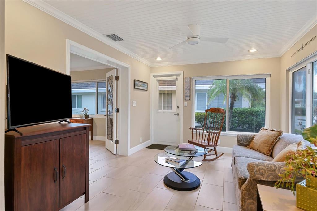 1900 Benjamin Franklin Drive, Unit V15 Sarasota, FL 34236 - Photo 16 of 39 a living room with furniture and a flat screen tv