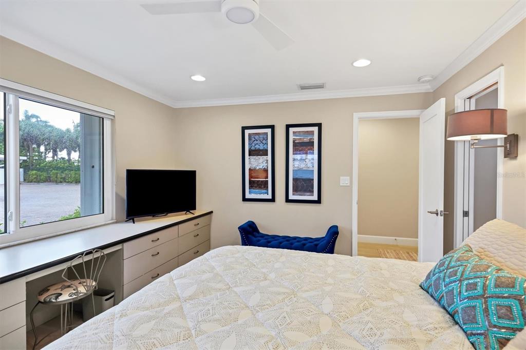 1900 Benjamin Franklin Drive, Unit V15 Sarasota, FL 34236 - Photo 18 of 39 a bedroom with a bed and a flat screen tv