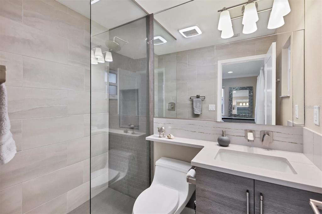 1900 Benjamin Franklin Drive, Unit V15 Sarasota, FL 34236 - Photo 19 of 39 a bathroom with a sink toilet and shower