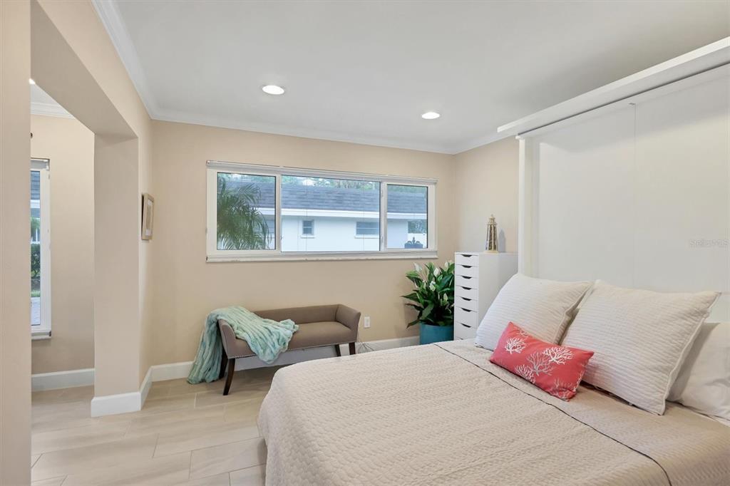 1900 Benjamin Franklin Drive, Unit V15 Sarasota, FL 34236 - Photo 22 of 39 a bedroom with a bed and window