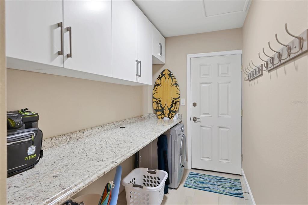 1900 Benjamin Franklin Drive, Unit V15 Sarasota, FL 34236 - Photo 24 of 39 a view of kitchen island with stainless steel appliances granite countertop cabinets and sink