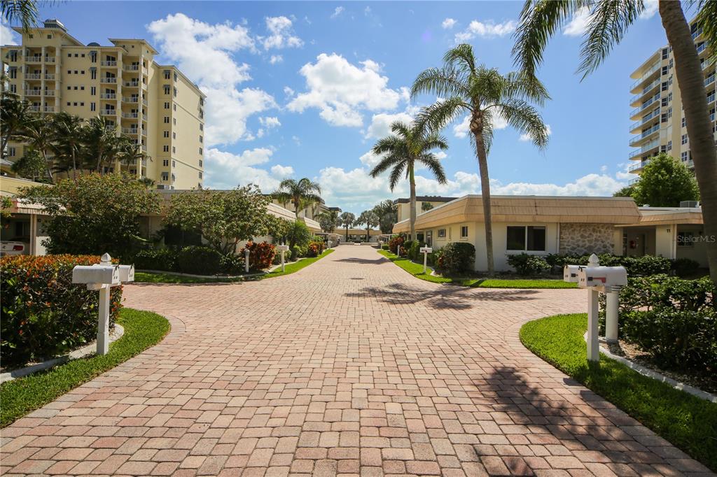 1900 Benjamin Franklin Drive, Unit V15 Sarasota, FL 34236 - Photo 26 of 39 a view of a garden with a fountain