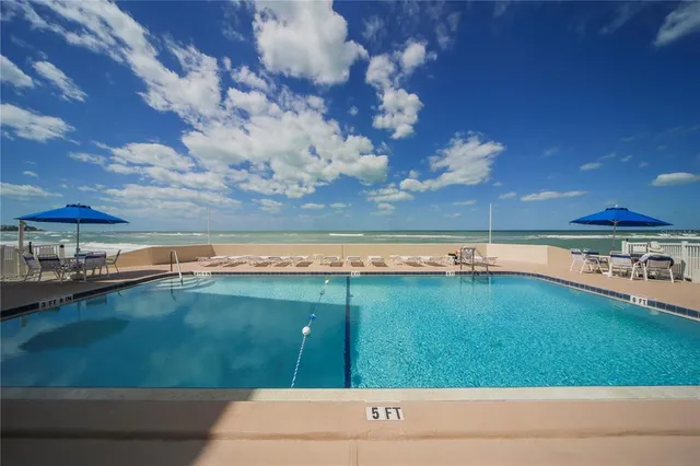 a view of a backyard with a swimming pool
