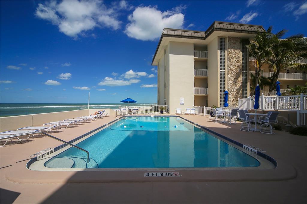 1900 Benjamin Franklin Drive, Unit V15 Sarasota, FL 34236 - Photo 28 of 39 a view of a backyard with a swimming pool