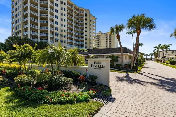 a kitchen with stainless steel appliances granite countertop a sink a stove a refrigerator and island