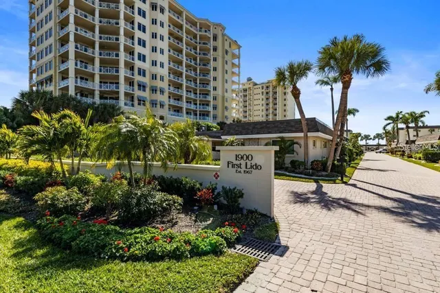 a kitchen with stainless steel appliances granite countertop a sink a stove a refrigerator and island