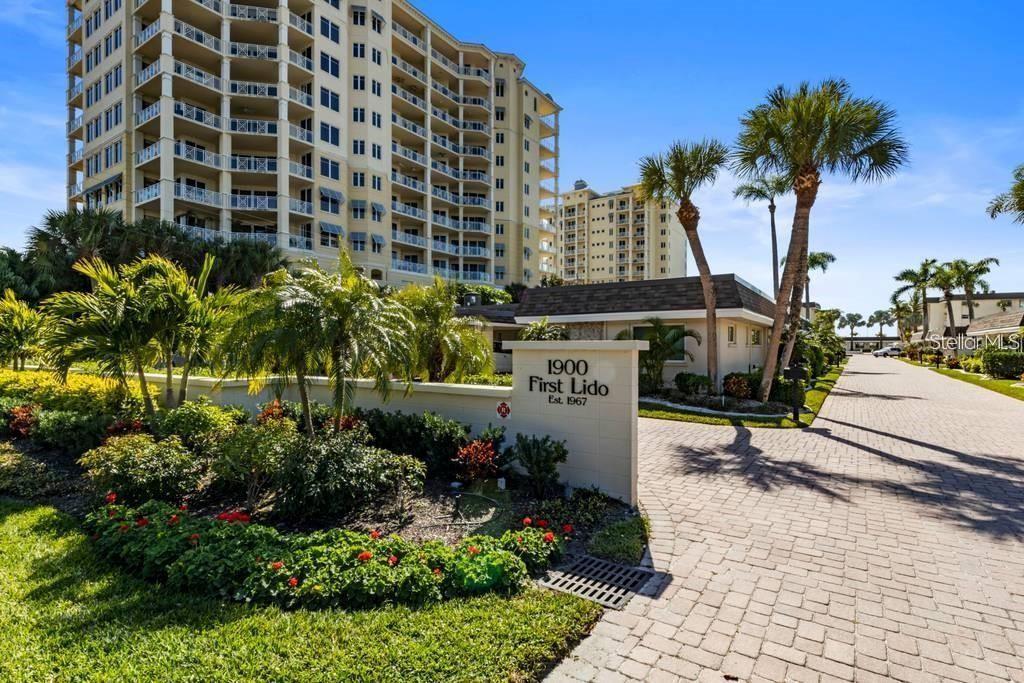 1900 Benjamin Franklin Drive, Unit V15 Sarasota, FL 34236 - Photo 3 of 39 a sign board with buildings in the background