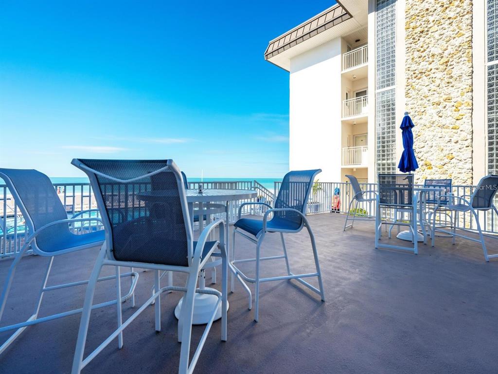 1900 Benjamin Franklin Drive, Unit V15 Sarasota, FL 34236 - Photo 35 of 39 a view of a dining room with furniture and wooden floor