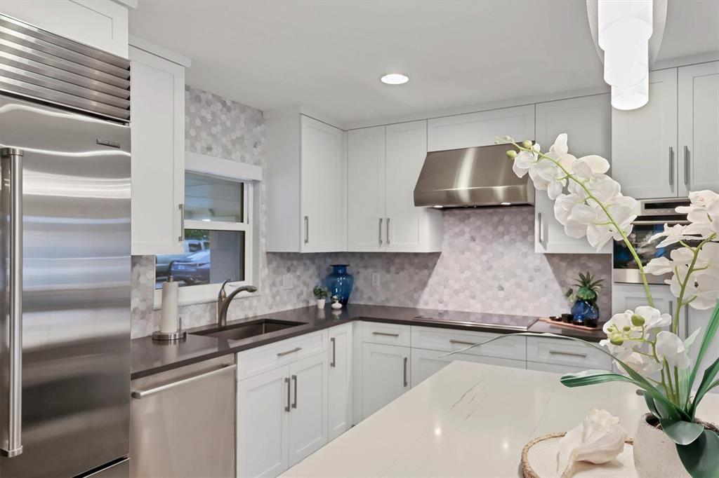 1900 Benjamin Franklin Drive, Unit V15 Sarasota, FL 34236 - Photo 6 of 39 a kitchen with granite countertop a sink stainless steel appliances and cabinets