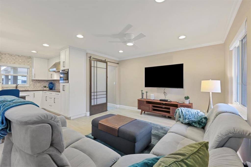 1900 Benjamin Franklin Drive, Unit V15 Sarasota, FL 34236 - Photo 9 of 39 a living room with furniture and a flat screen tv