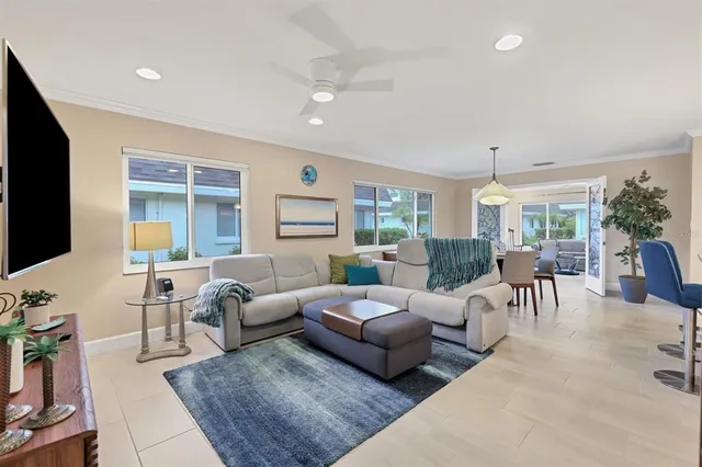 a living room with furniture white walls and wooden floor