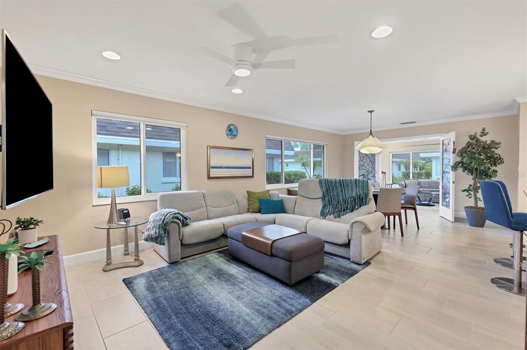 1900 Benjamin Franklin Drive, Unit V15 Sarasota, FL 34236 - Photo 10 of 39 a living room with furniture and a flat screen tv
