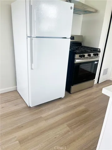 a kitchen with a stove and a refrigerator