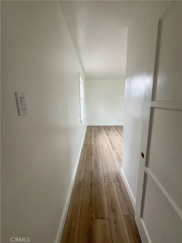 a view of a hallway view with wooden floor