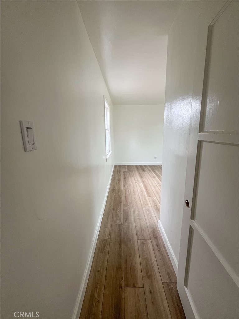 4512 Linsley Street Compton, CA 90221 - Photo 6 of 8 a view of a hallway view with wooden floor