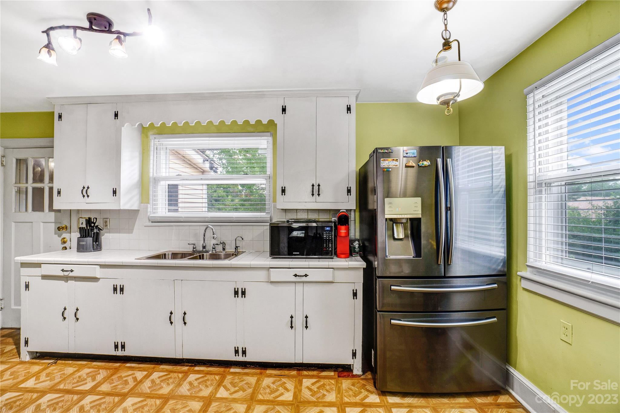 6512 Tuckaseegee Road Charlotte, NC 28214 - Photo 11 of 47 a kitchen with stainless steel appliances a refrigerator sink and white cabinets