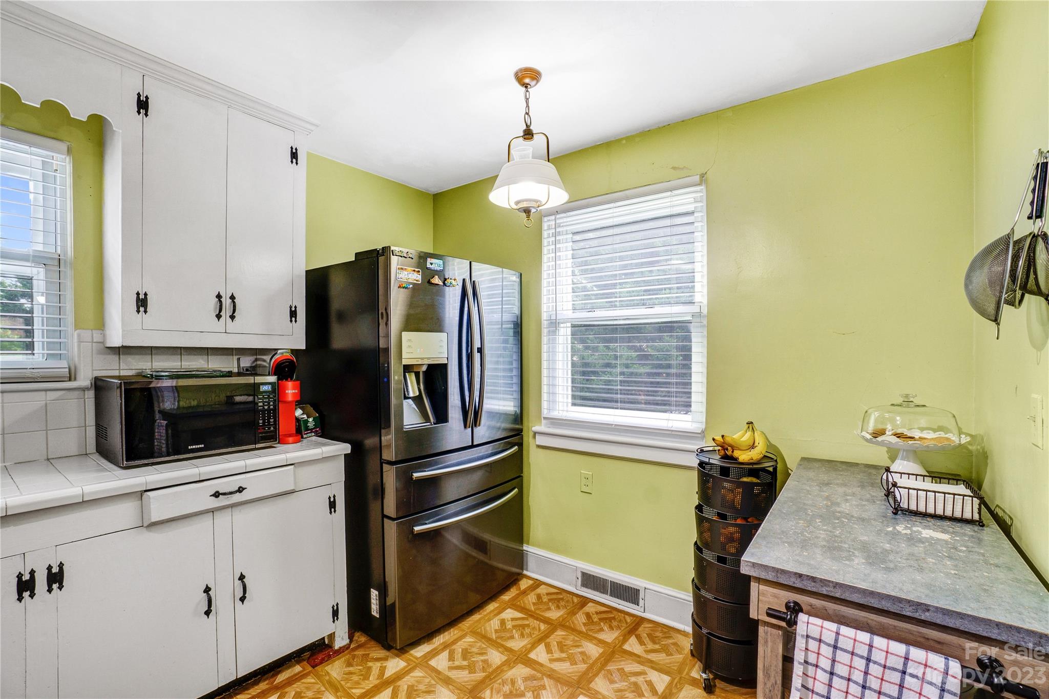 6512 Tuckaseegee Road Charlotte, NC 28214 - Photo 12 of 47 a kitchen with sink refrigerator and microwave