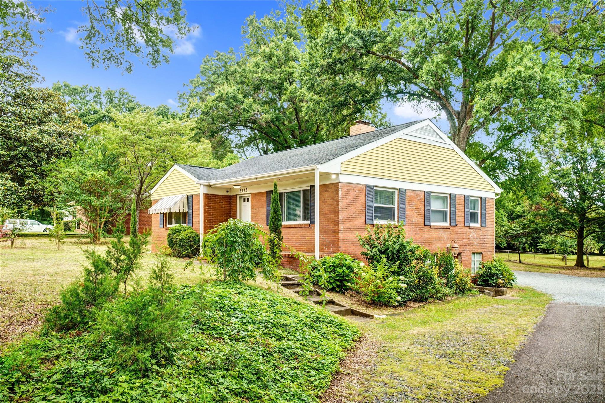 6512 Tuckaseegee Road Charlotte, NC 28214 - Photo 2 of 47 a front view of a house with a yard