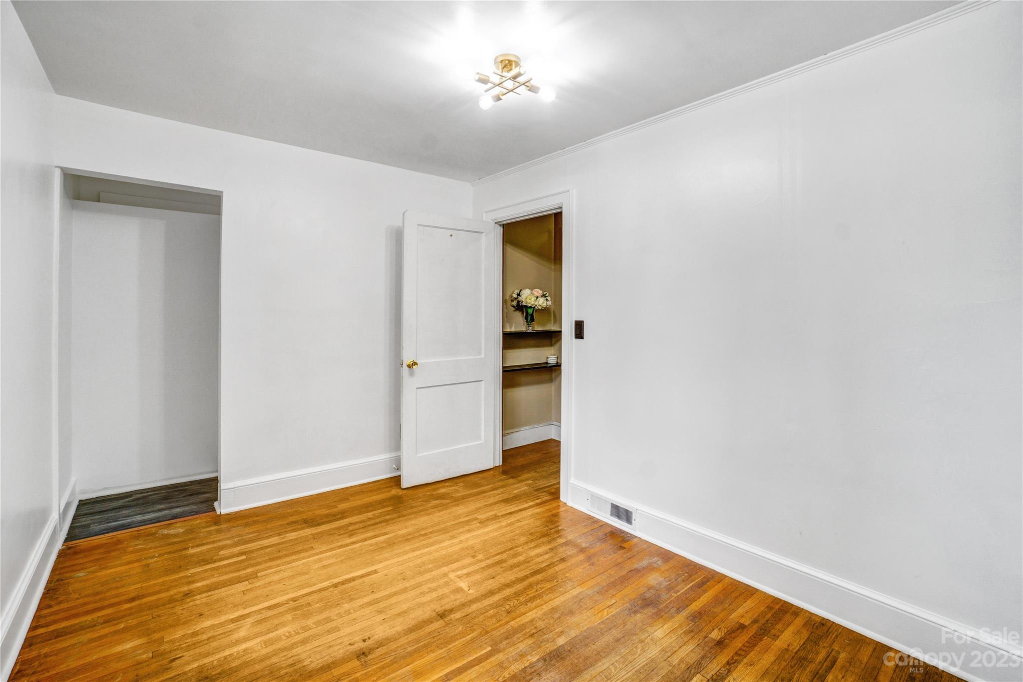 6512 Tuckaseegee Road Charlotte, NC 28214 - Photo 27 of 47 a view of empty room with wooden floor and fan