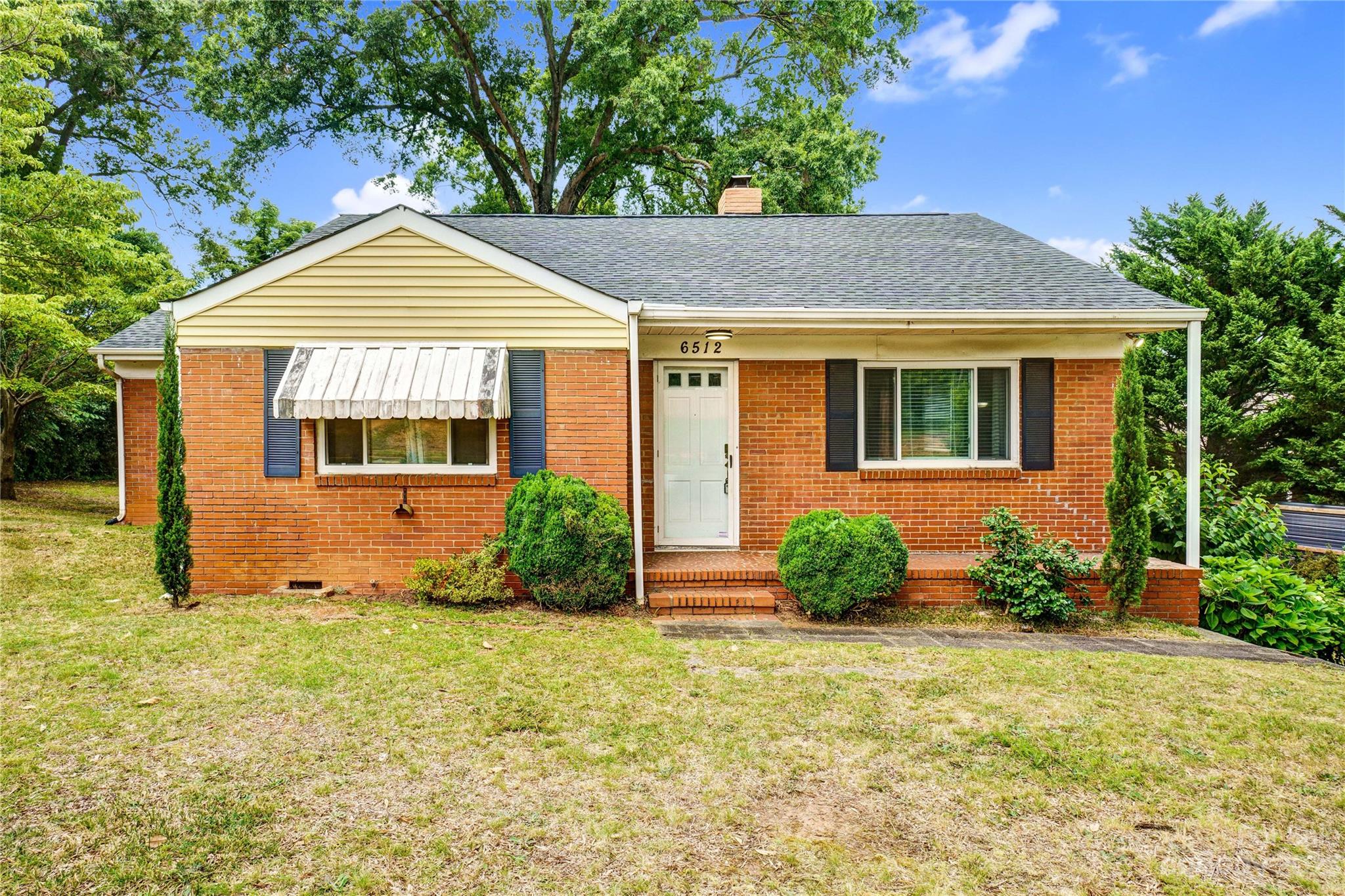 6512 Tuckaseegee Road Charlotte, NC 28214 - Photo 3 of 47 a front view of a house with garden