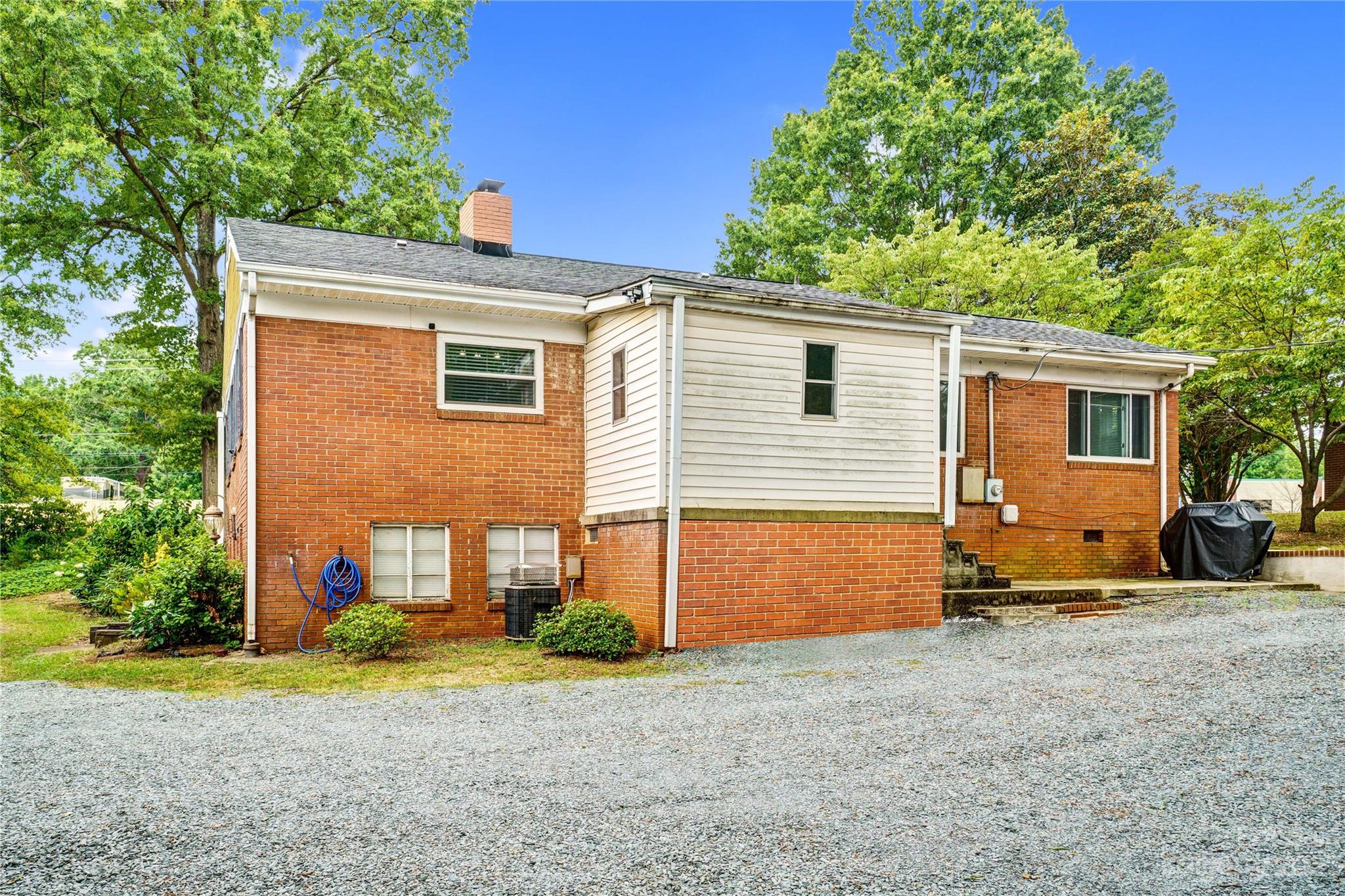 6512 Tuckaseegee Road Charlotte, NC 28214 - Photo 39 of 47 a backyard of a house with barbeque oven table and chairs