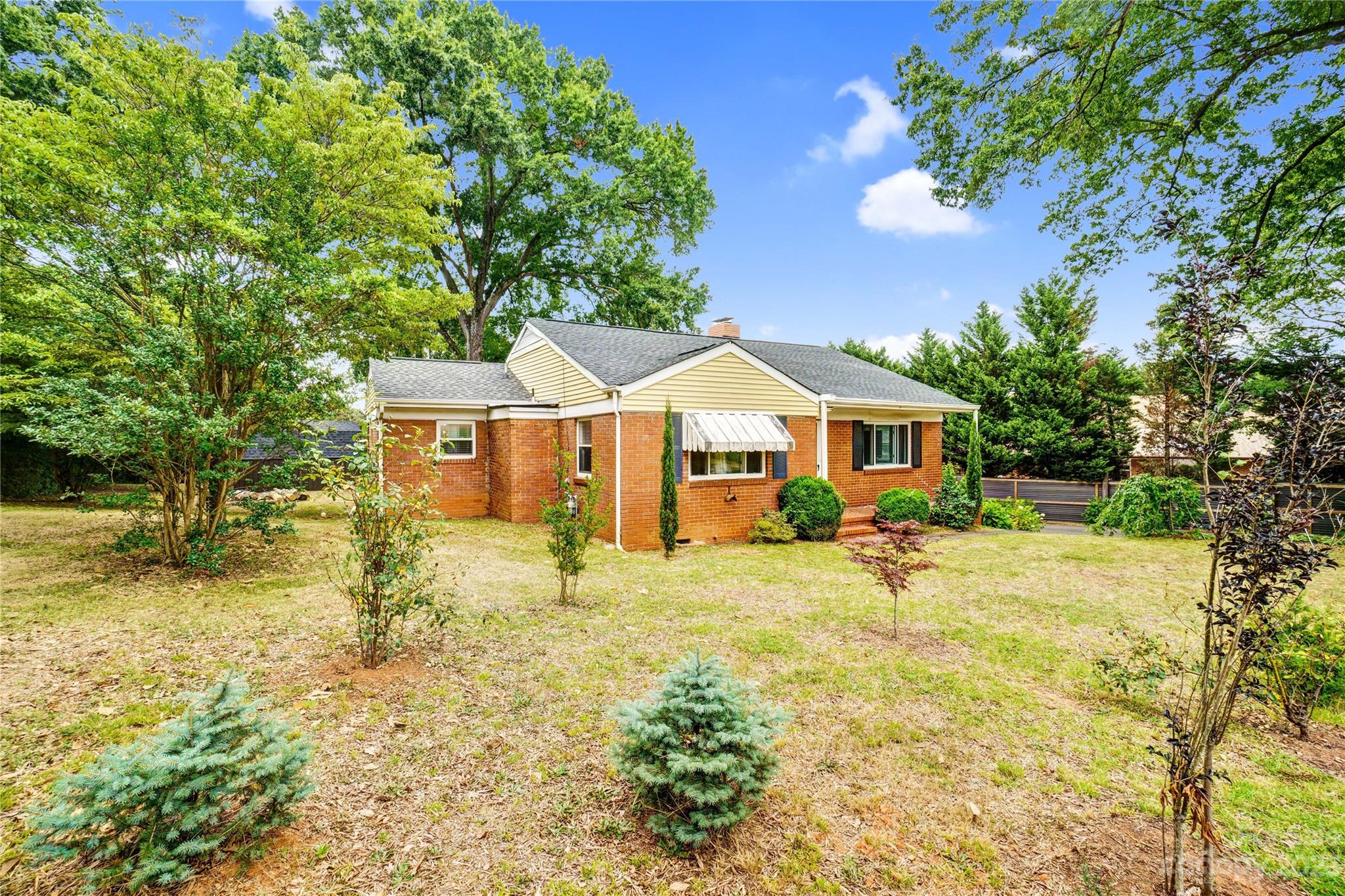 6512 Tuckaseegee Road Charlotte, NC 28214 - Photo 4 of 47 a front view of a house with a yard