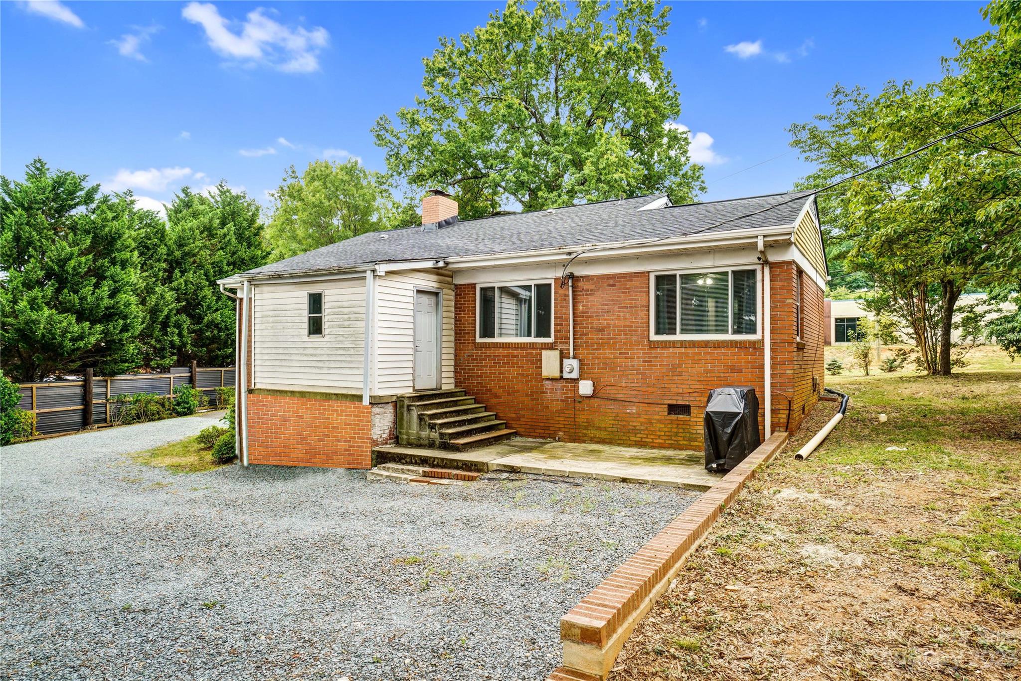 6512 Tuckaseegee Road Charlotte, NC 28214 - Photo 41 of 47 a view of house with backyard and trees