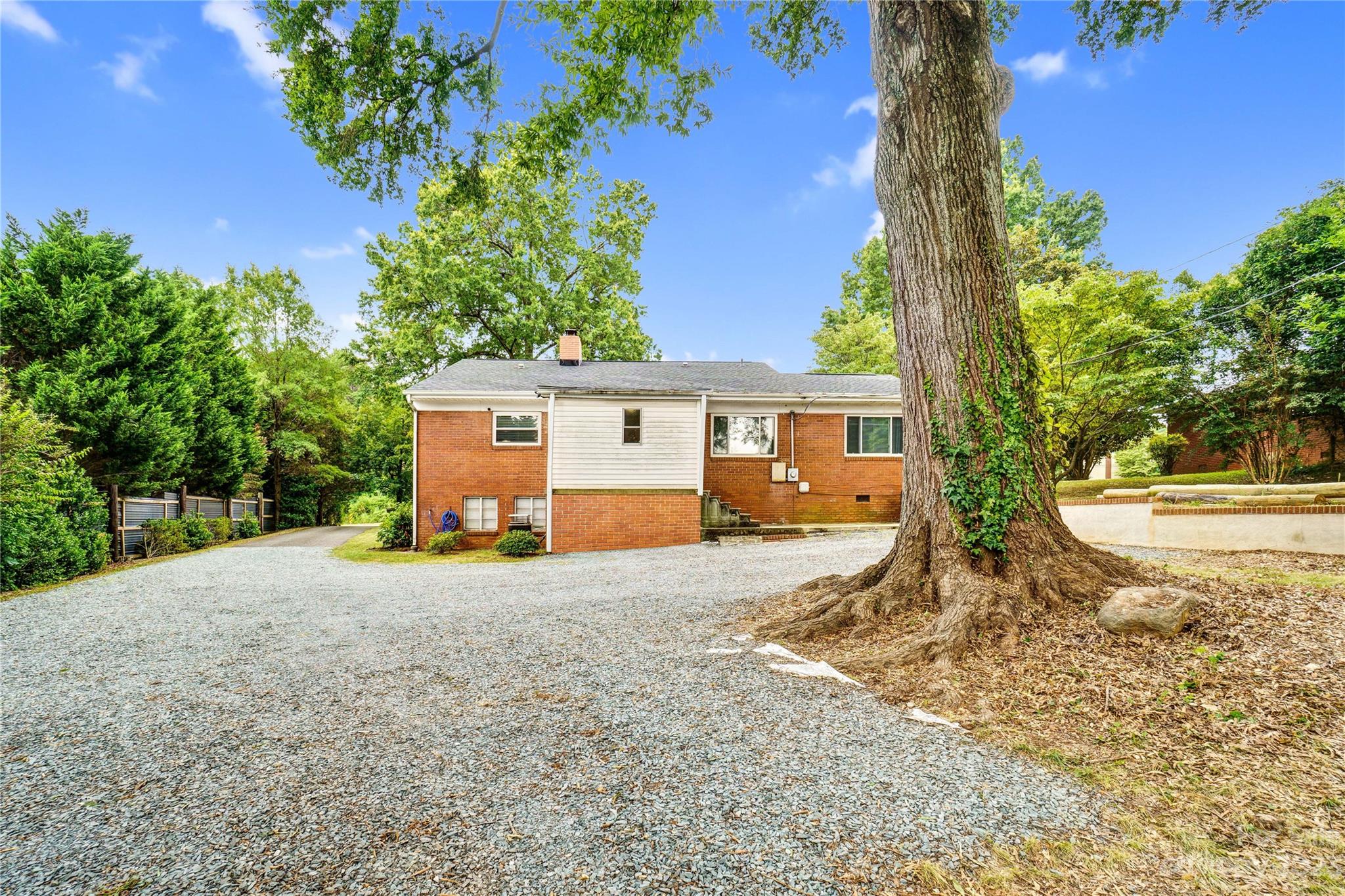 6512 Tuckaseegee Road Charlotte, NC 28214 - Photo 42 of 47 a view of a house with backyard and a tree