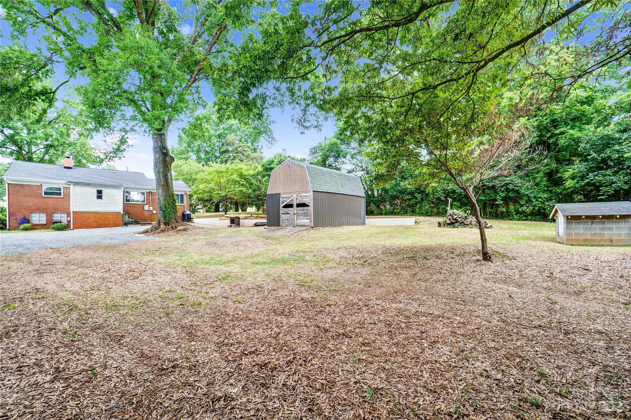 6512 Tuckaseegee Road Charlotte, NC 28214 - Photo 45 of 47 a house with trees in front of it