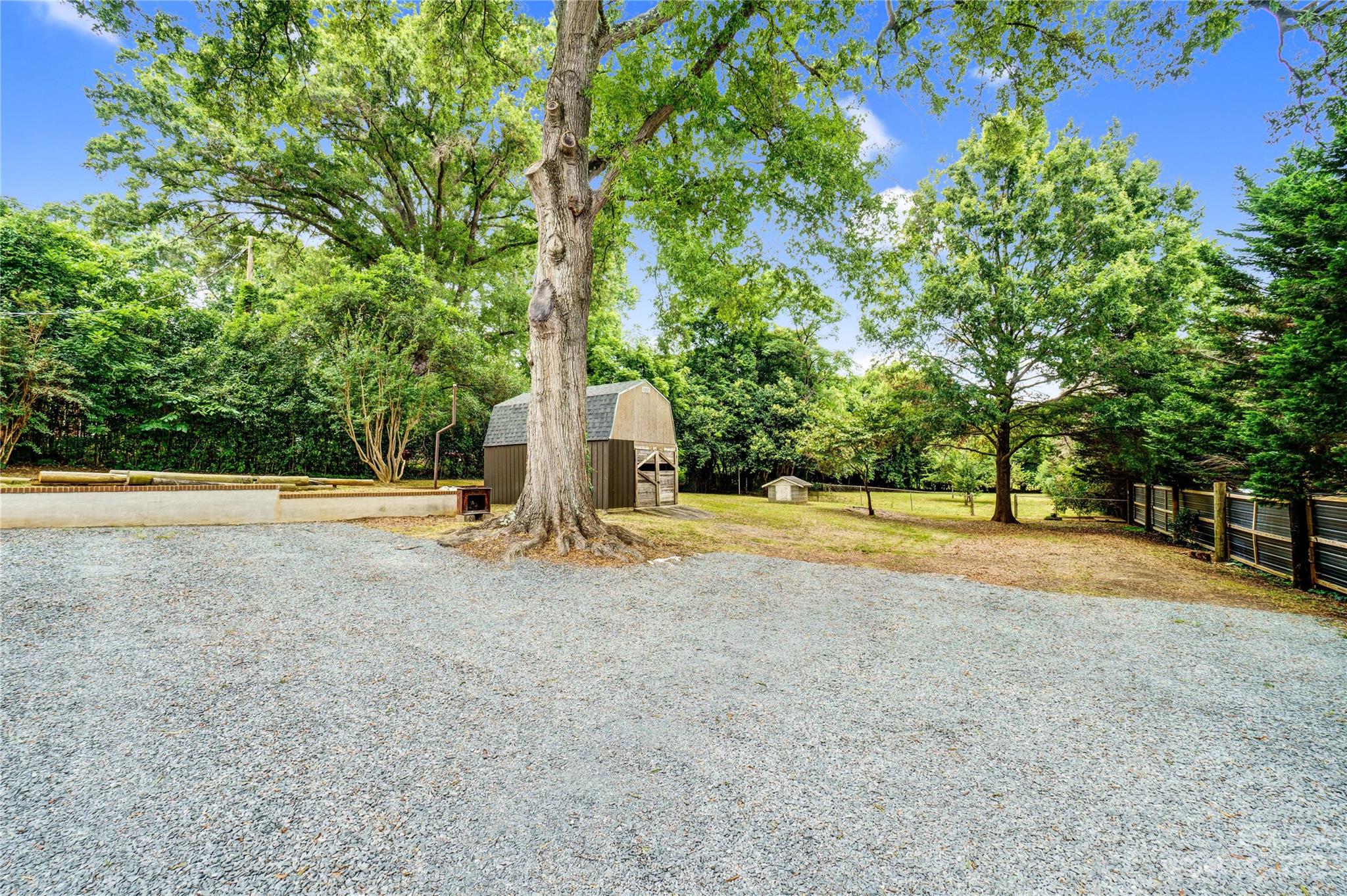 6512 Tuckaseegee Road Charlotte, NC 28214 - Photo 46 of 47 a view of yard with swimming pool and large trees