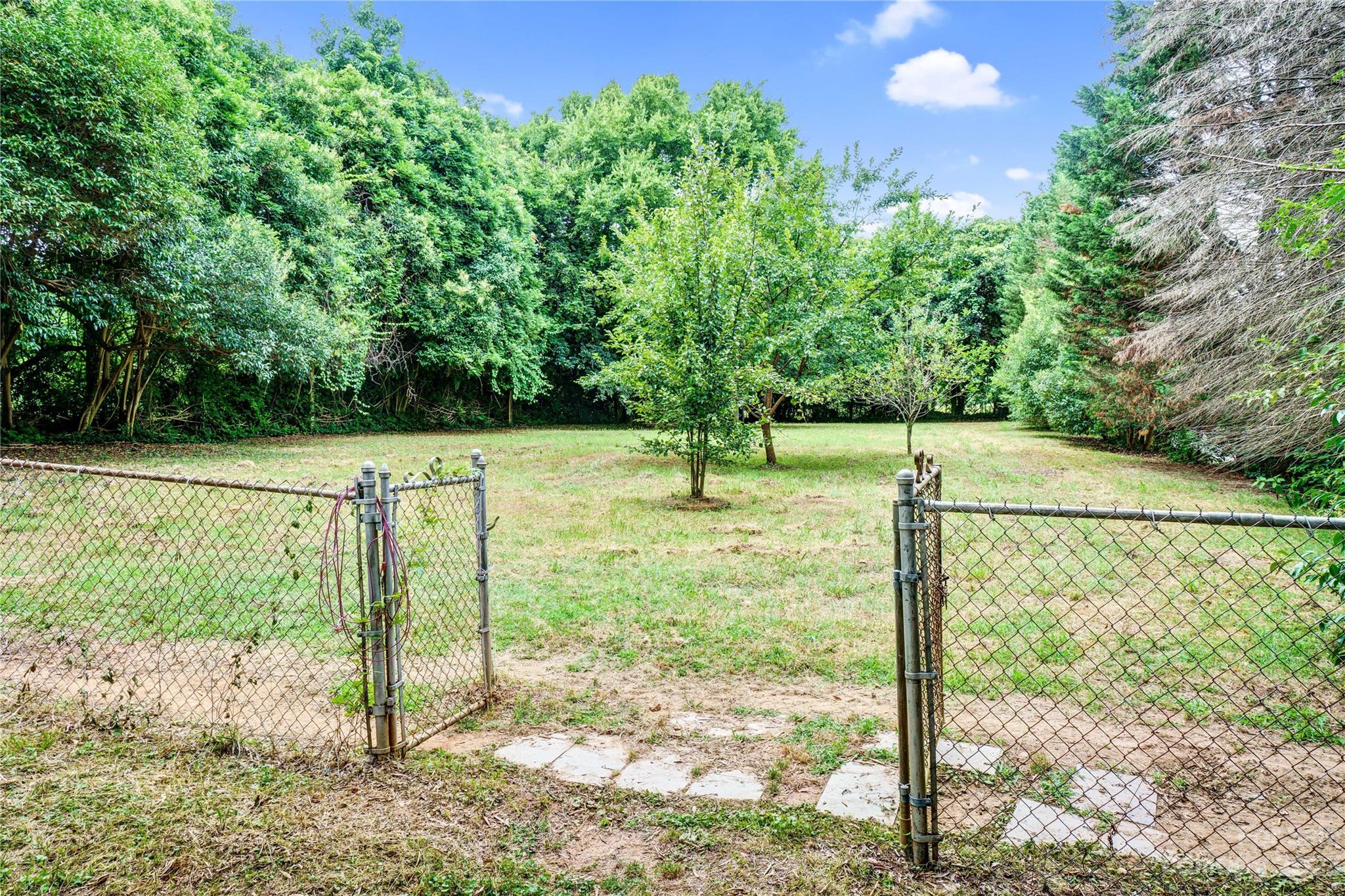 6512 Tuckaseegee Road Charlotte, NC 28214 - Photo 47 of 47 a view of a field with a tree in the background