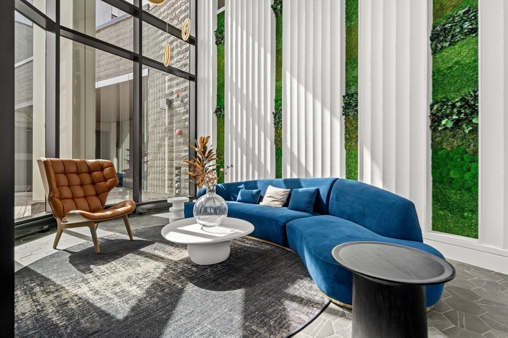 1515 Commonwealth Avenue, Unit 504 Boston, MA 02135 - Photo 16 of 41 a living room with furniture and a large window