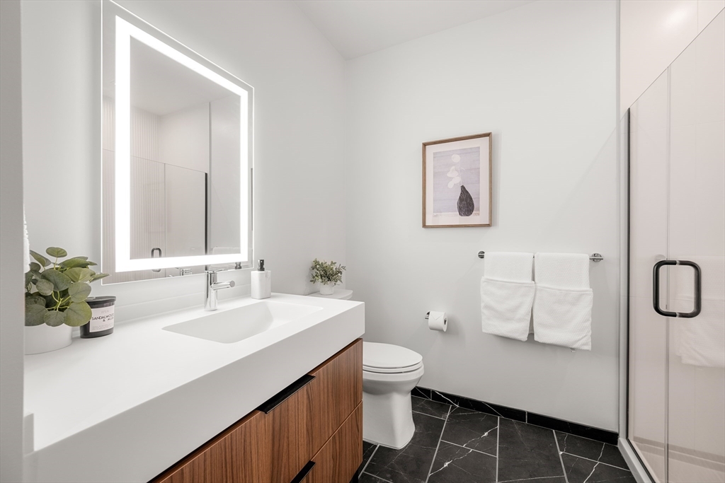 1515 Commonwealth Avenue, Unit 504 Boston, MA 02135 - Photo 4 of 41 a bathroom with a sink and a mirror