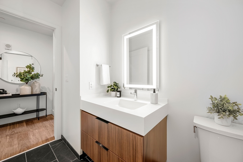 1515 Commonwealth Avenue, Unit 504 Boston, MA 02135 - Photo 5 of 41 a bathroom with a sink and a mirror