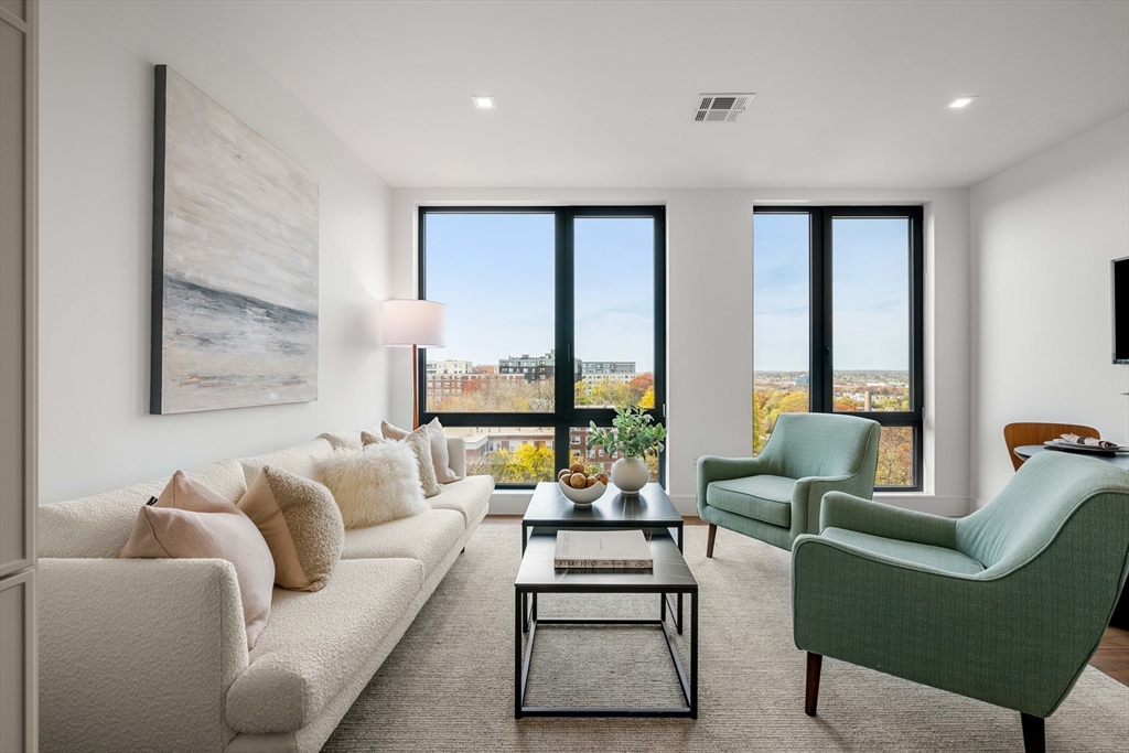 1515 Commonwealth Avenue, Unit 504 Boston, MA 02135 - Photo 8 of 41 a living room with furniture and floor to ceiling windows