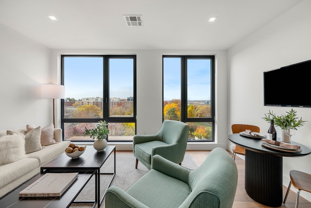 1515 Commonwealth Avenue, Unit 504 Boston, MA 02135 - Photo 10 of 41 a living room with furniture and a flat screen tv