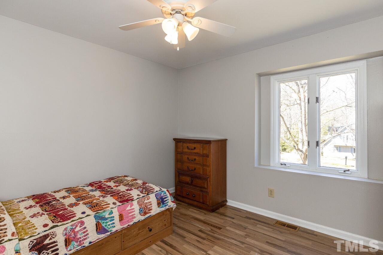 4017 Grimstead Lane Raleigh, NC 27613 - Photo 17 of 30 a bedroom with a bed and a window