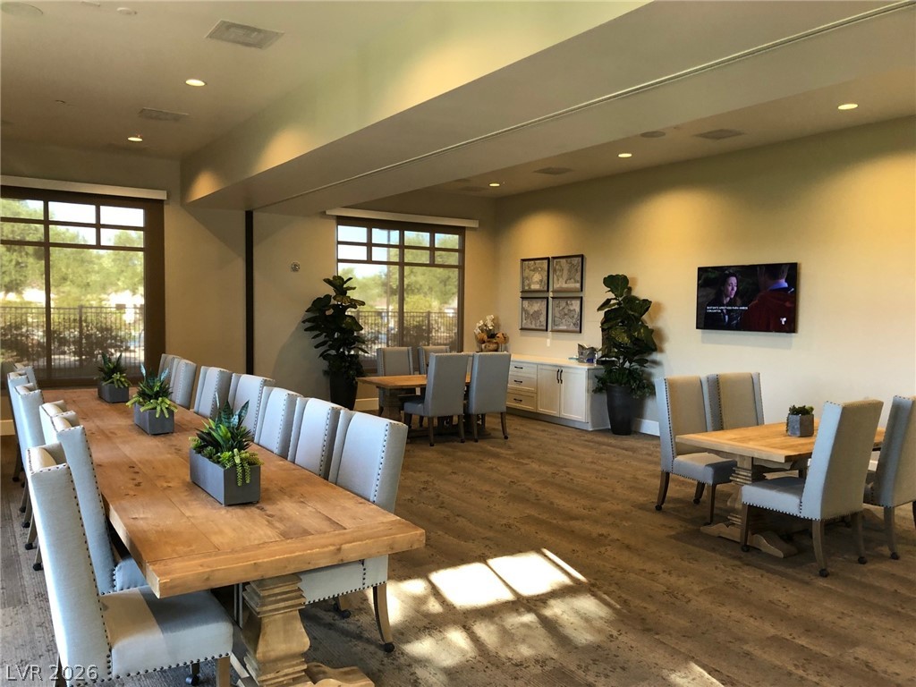 498 Pebble Run Avenue Henderson, NV 89011 - Photo 40 of 47 This communal dining area showcases durable wood-look flooring and generous windows overlooking exterior foliage.
