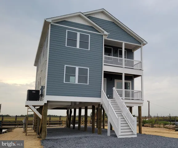 a front view of a house with many windows