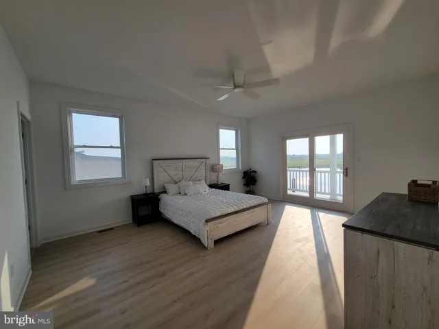 a spacious bedroom with a bed and window