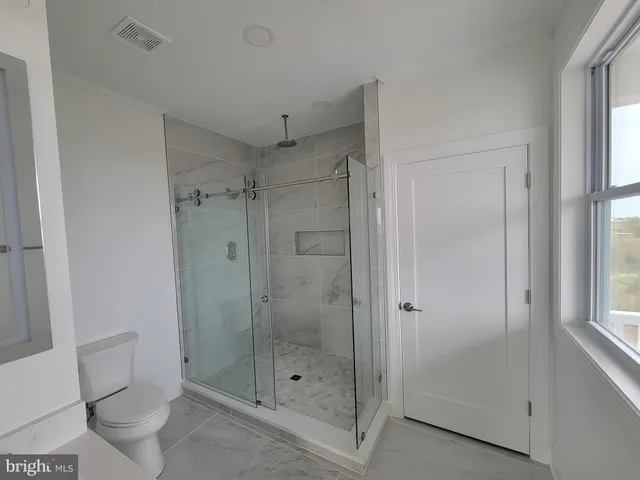 a bathroom with a shower and a toilet