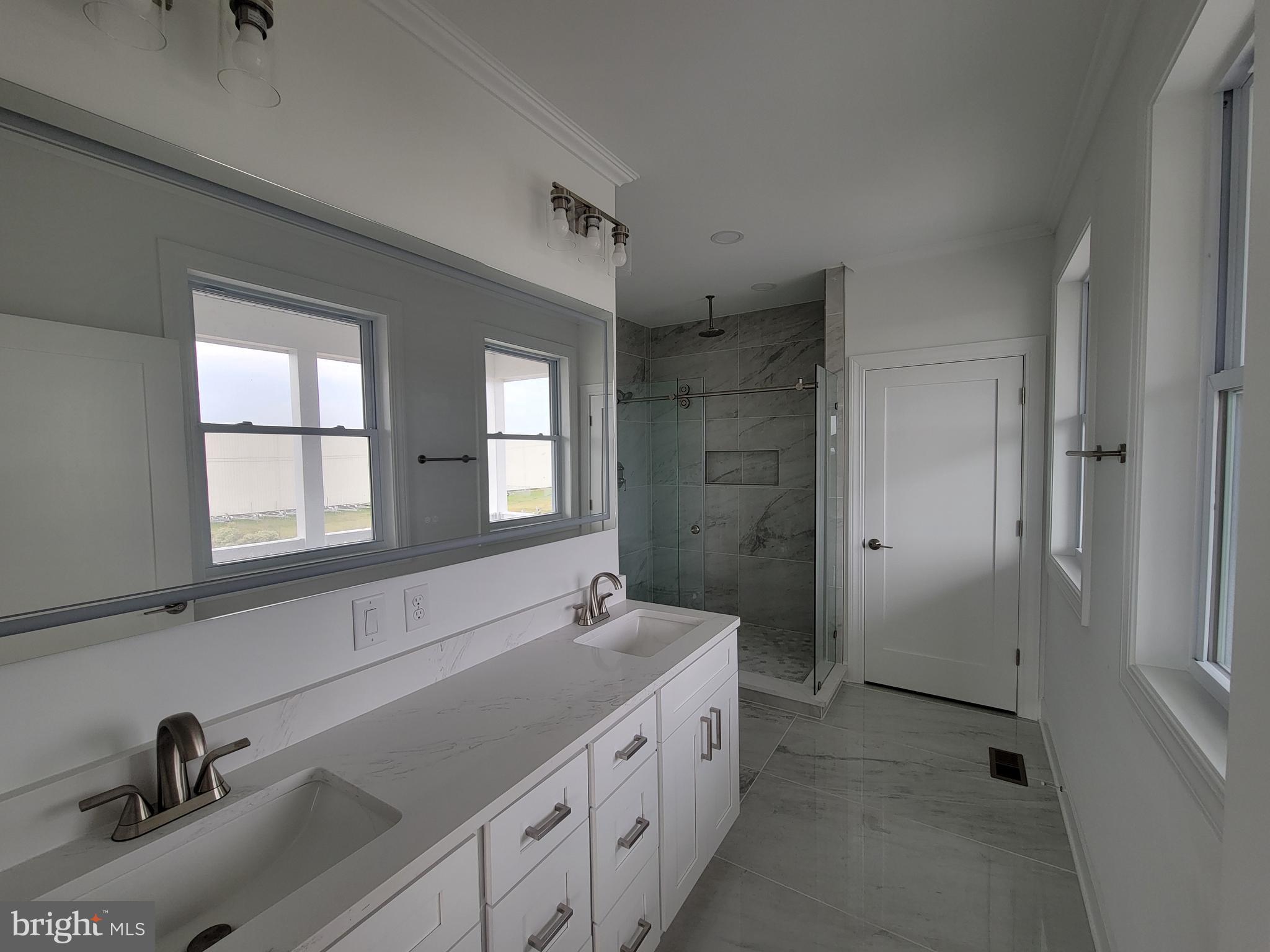 116 Sawyer Road Milford, DE 19963 - Photo 21 of 33 a spacious bathroom with a double vanity sink a mirror and a bathtub