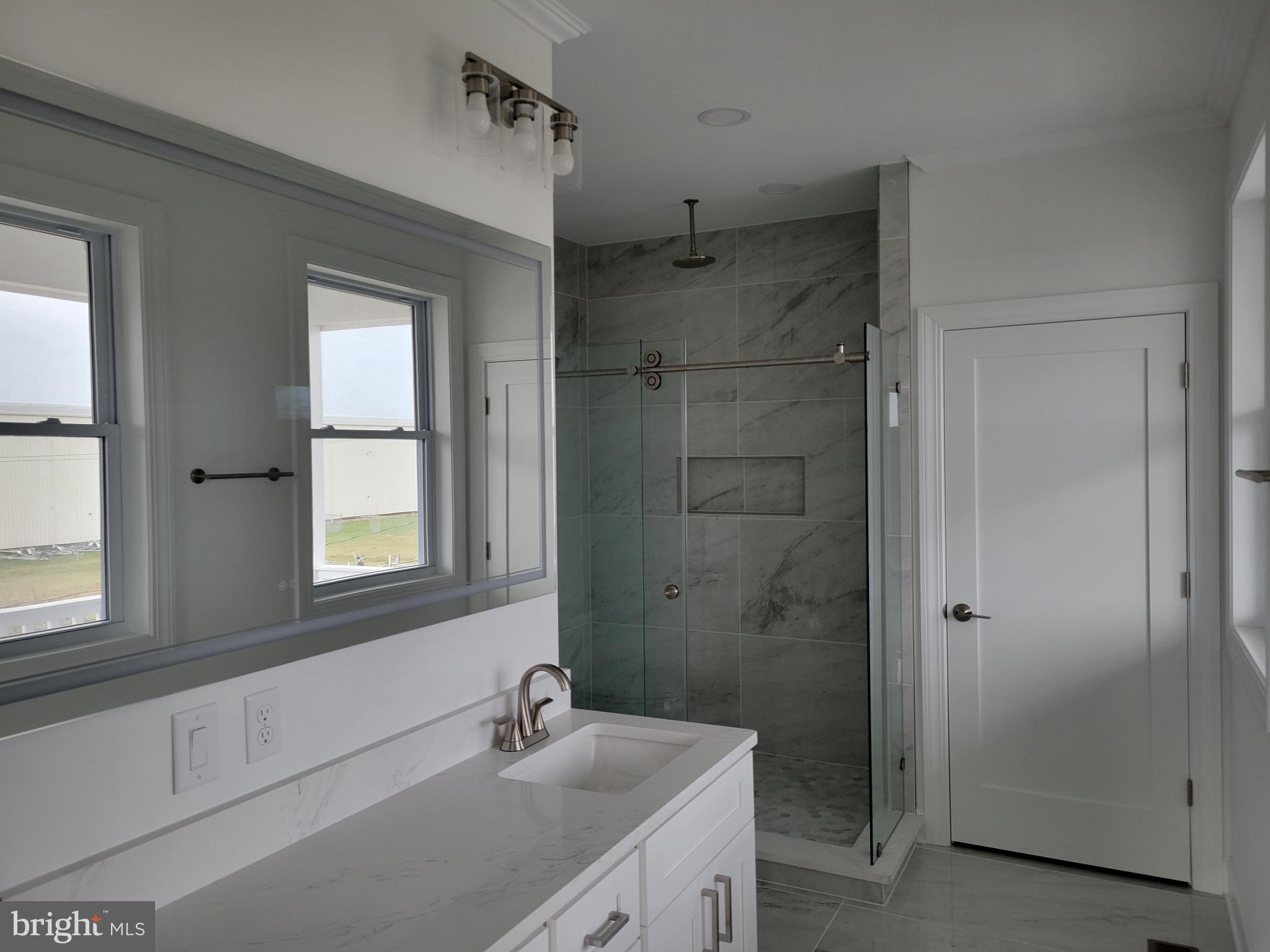 116 Sawyer Road Milford, DE 19963 - Photo 22 of 33 a bathroom with a shower sink and mirror