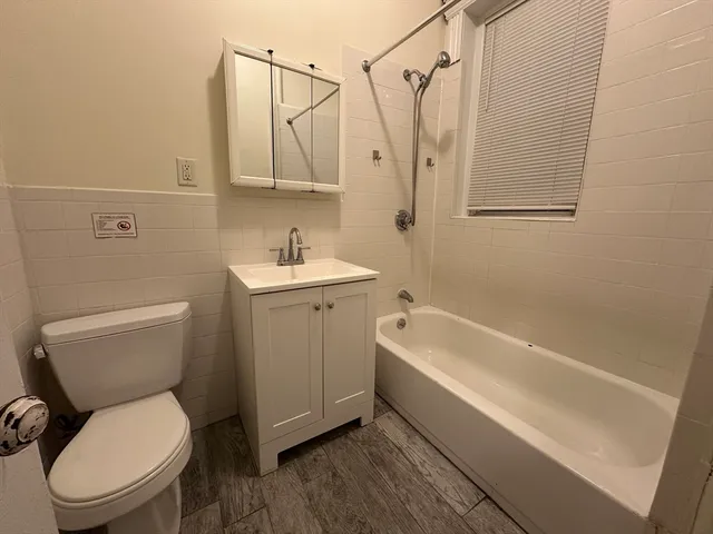 a bathroom with a toilet a sink and bathtub