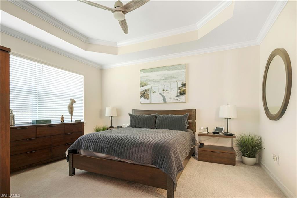 329 Deauville Loop Naples, FL 34114 - Photo 10 of 22 a bedroom with a bed a couch and a window
