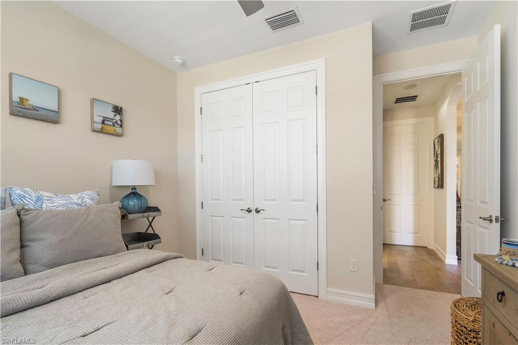 329 Deauville Loop Naples, FL 34114 - Photo 16 of 22 a bedroom with a bed and a couch