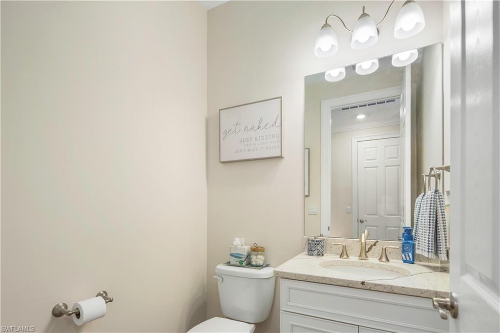 329 Deauville Loop Naples, FL 34114 - Photo 17 of 22 a bathroom with a sink and a mirror