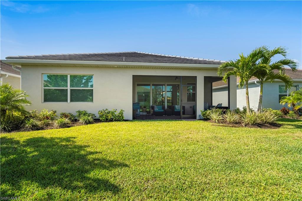 329 Deauville Loop Naples, FL 34114 - Photo 21 of 22 front view of a house with a yard