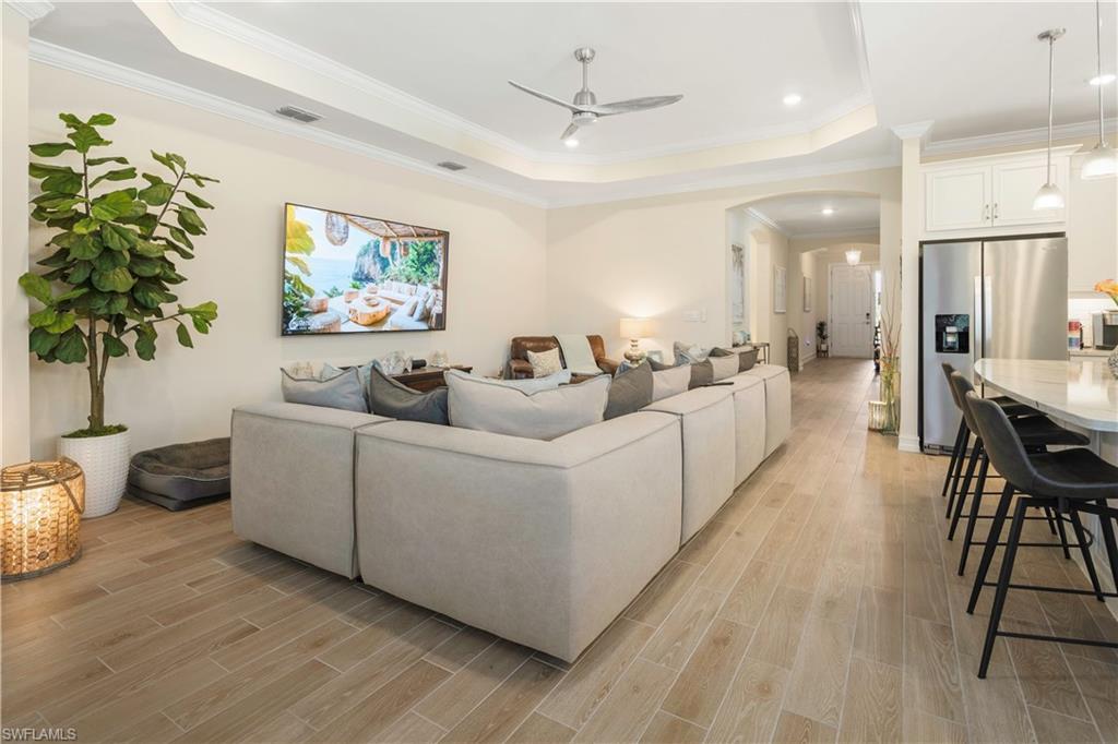 329 Deauville Loop Naples, FL 34114 - Photo 4 of 22 a living room with furniture and a potted plant